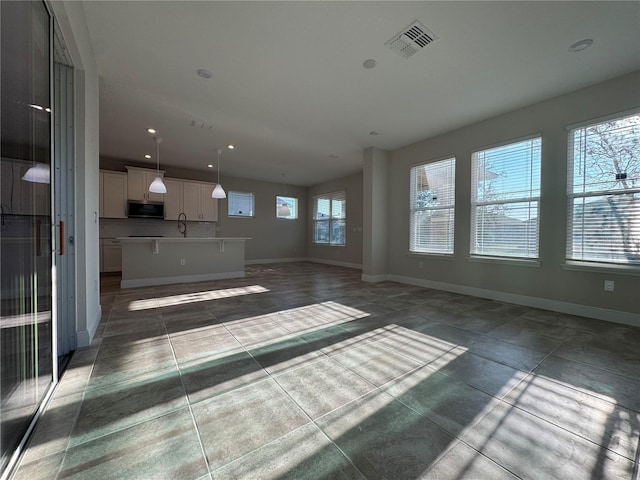 unfurnished living room with sink