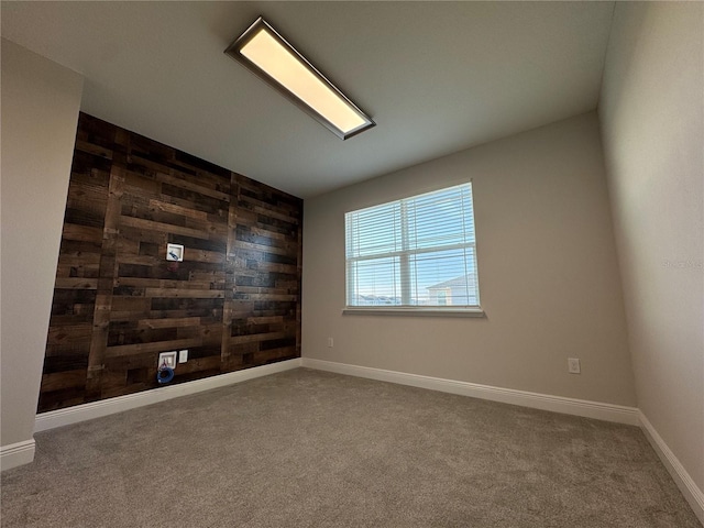 carpeted empty room with wooden walls