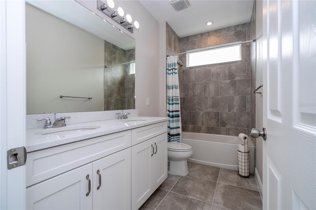 full bathroom featuring vanity, shower / bath combo with shower curtain, and toilet