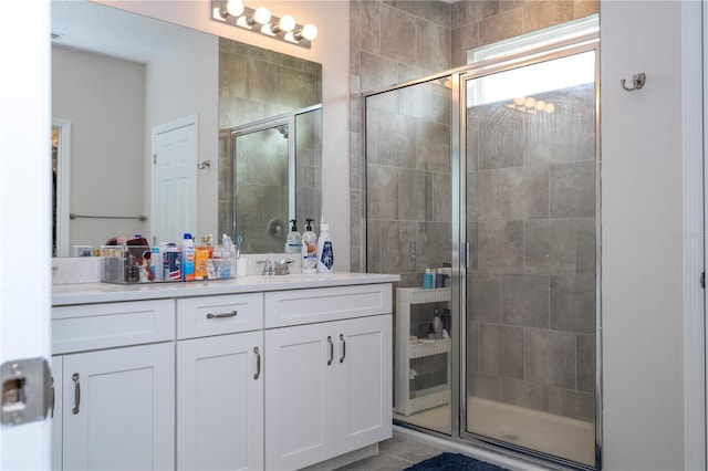 bathroom featuring walk in shower and vanity