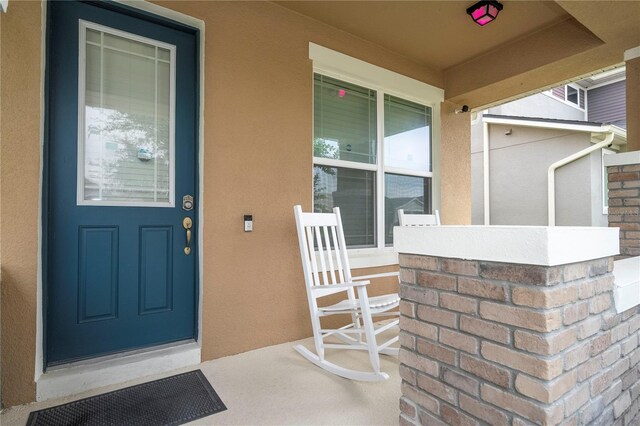 entrance to property featuring covered porch