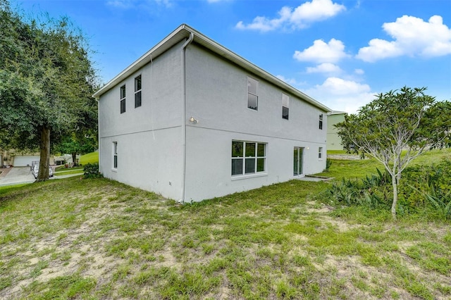 view of side of home with a yard