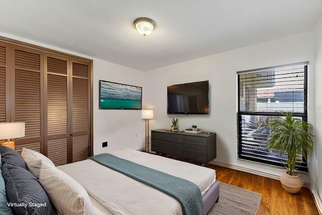 bedroom featuring hardwood / wood-style floors and a closet