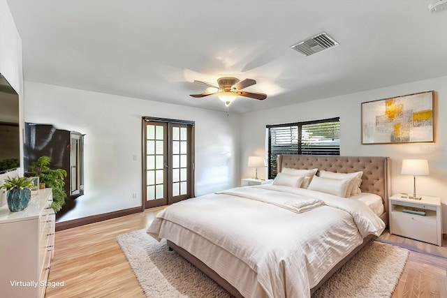 bedroom with french doors, ceiling fan, and light wood-type flooring