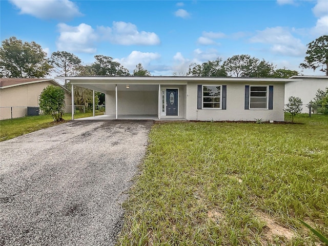 view of front of house featuring a carport and a front lawn