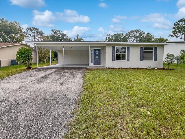 single story home with a front yard and a carport