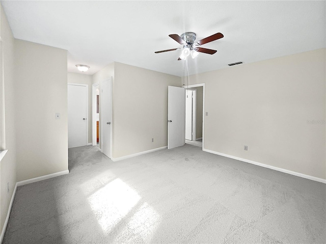 unfurnished room featuring ceiling fan and light carpet