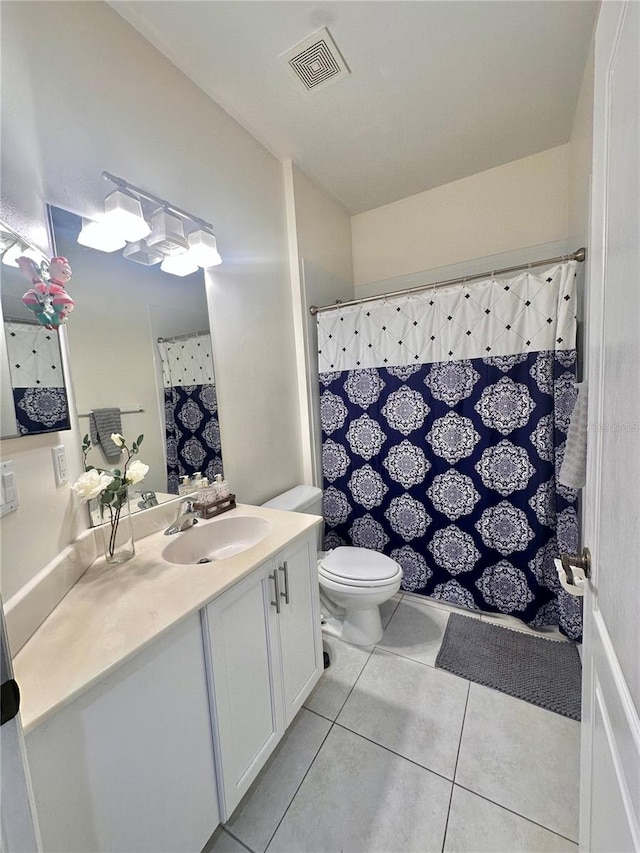 bathroom with a shower with shower curtain, tile patterned flooring, toilet, and vanity