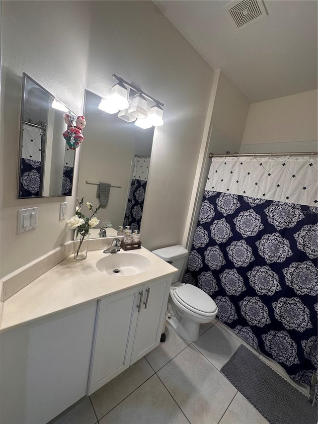 bathroom with tile patterned floors, a shower with curtain, toilet, and vanity