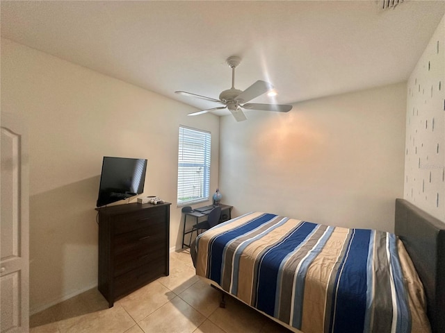 tiled bedroom featuring ceiling fan