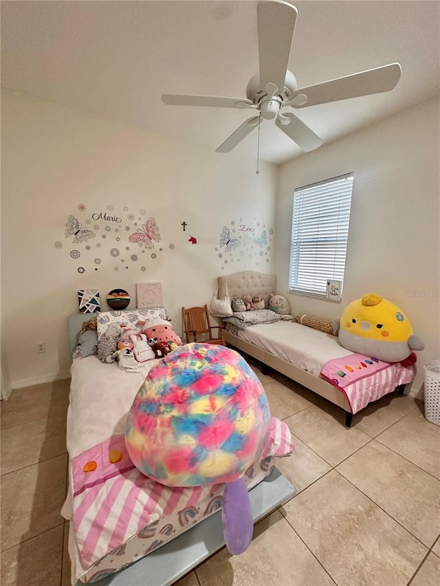 tiled bedroom featuring ceiling fan