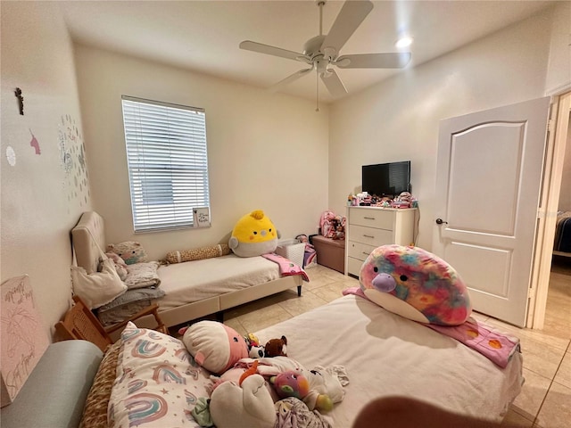 interior space with light tile patterned floors and ceiling fan