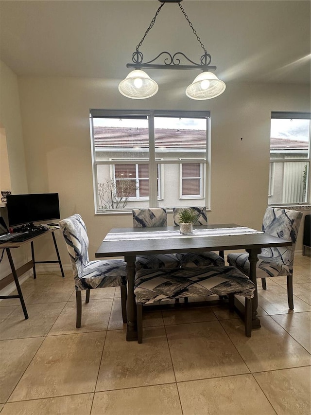 dining space with light tile patterned floors and a wealth of natural light