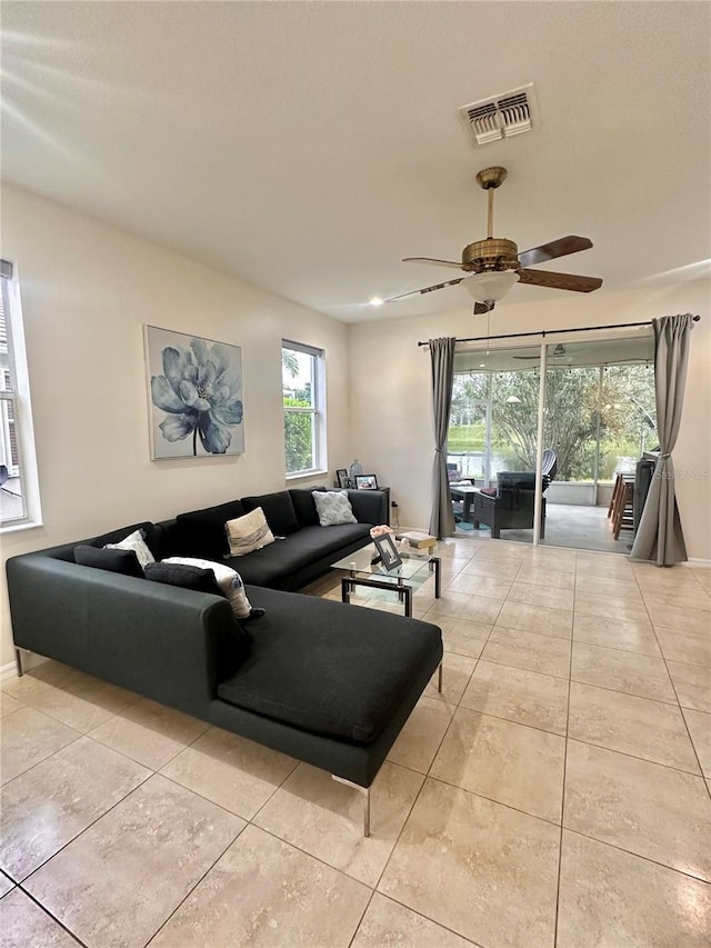 tiled living room with ceiling fan