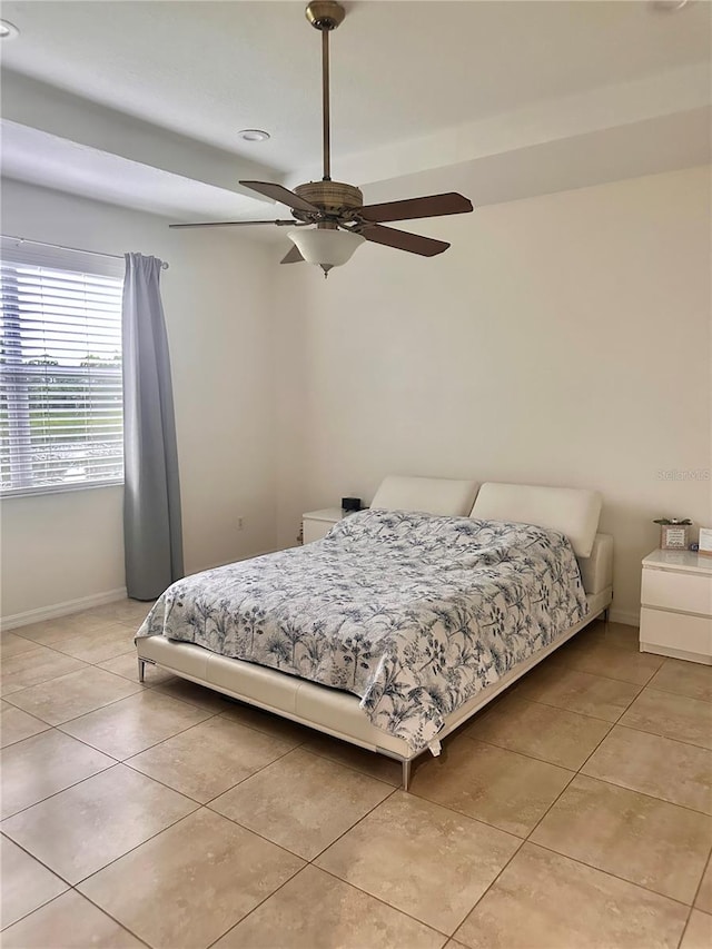 tiled bedroom featuring ceiling fan