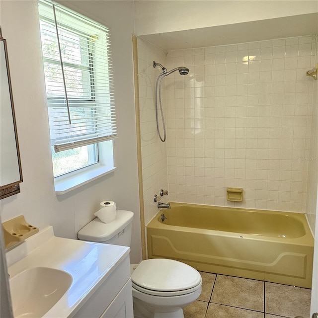 full bathroom featuring tiled shower / bath, vanity, toilet, and tile patterned floors