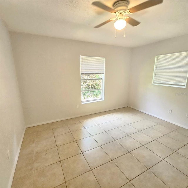 tiled empty room with ceiling fan