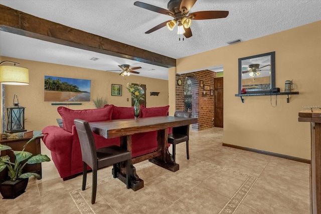 dining room featuring beamed ceiling and a textured ceiling