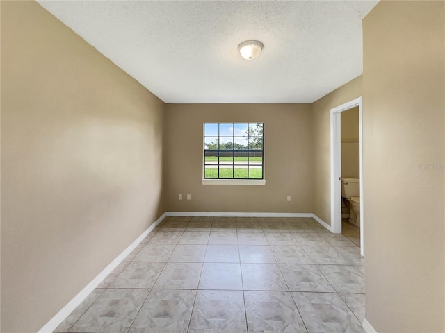 empty room featuring a textured ceiling