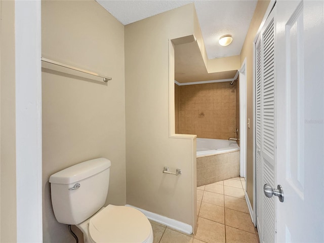 bathroom featuring a textured ceiling, tiled shower / bath combo, toilet, and tile patterned floors