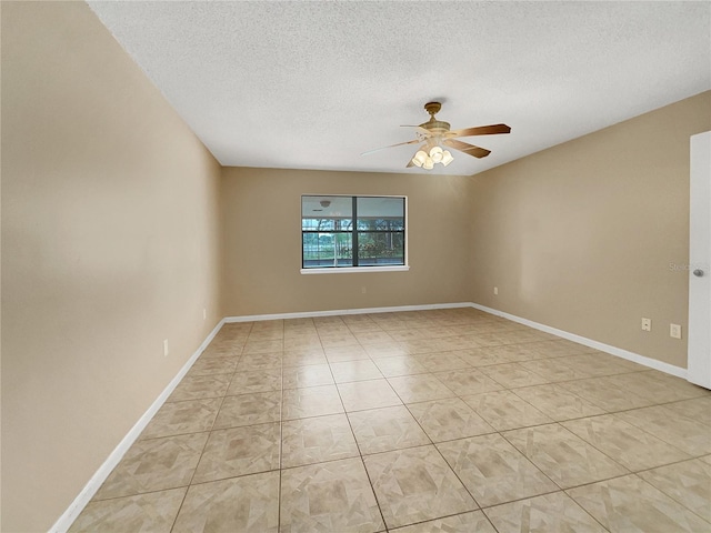 unfurnished room featuring a textured ceiling, light tile patterned flooring, and ceiling fan