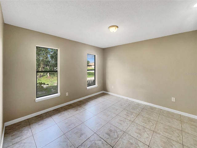 empty room featuring a textured ceiling