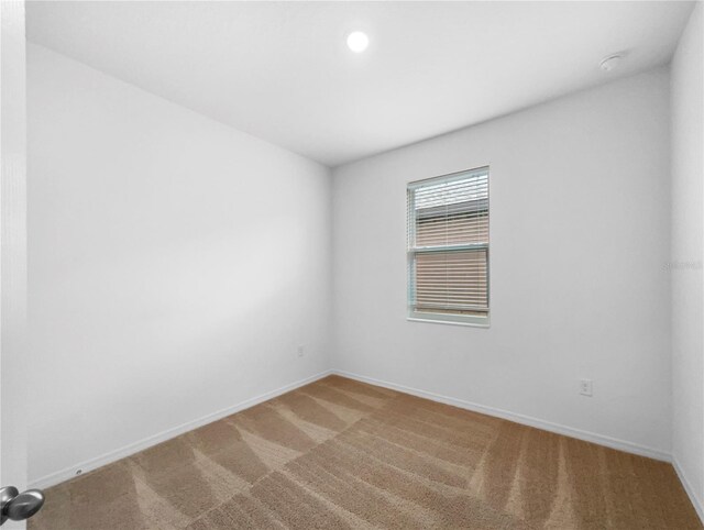 empty room featuring light colored carpet