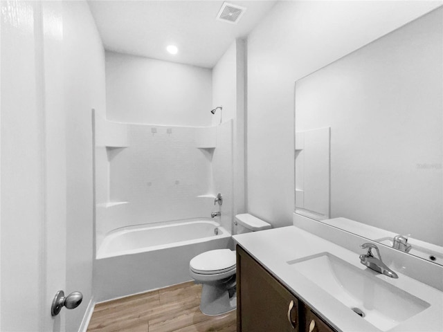 full bath with vanity, wood finished floors, visible vents, tub / shower combination, and toilet