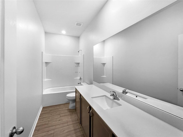 full bathroom with vanity, toilet, hardwood / wood-style floors, and shower / bathing tub combination