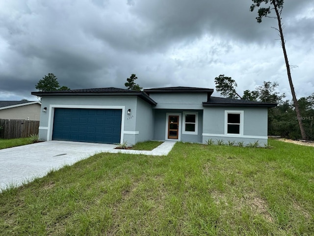 view of front of house with a garage and a front yard