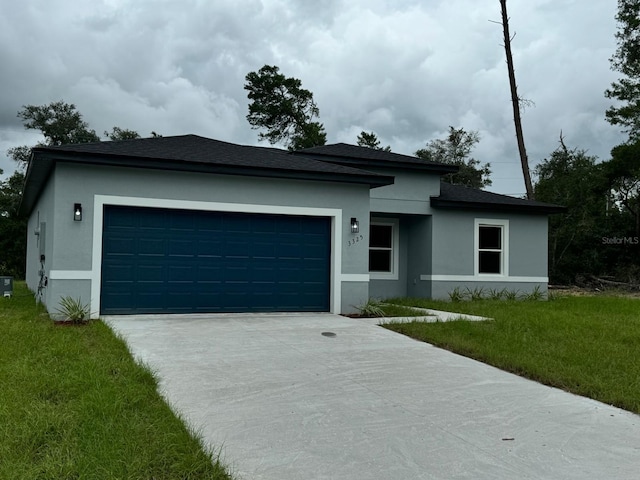 view of front of property with a garage and a front lawn