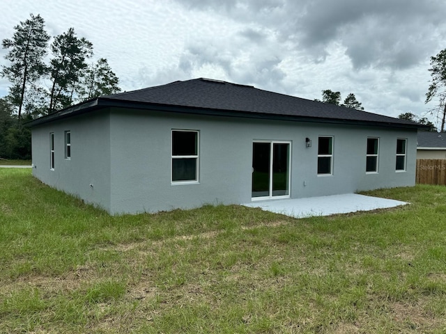 rear view of property featuring a yard and a patio