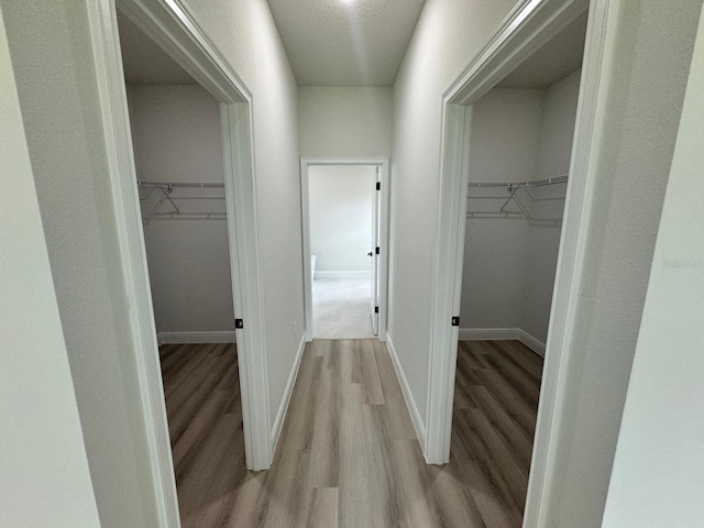 corridor with light hardwood / wood-style flooring