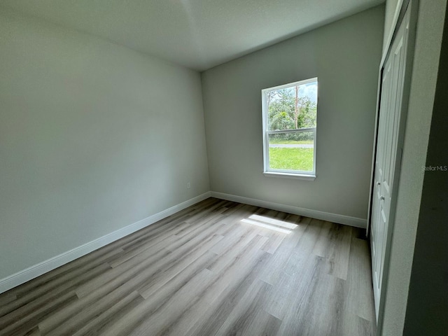 unfurnished room with light hardwood / wood-style floors