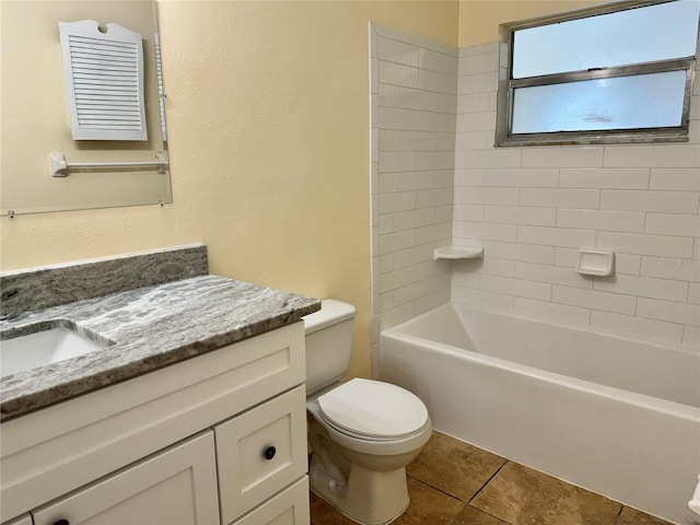 full bathroom featuring tile patterned floors, toilet, tiled shower / bath combo, and vanity