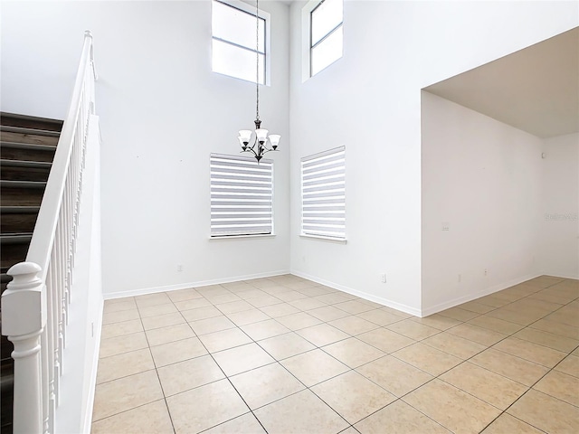 interior space featuring light tile patterned floors and an inviting chandelier