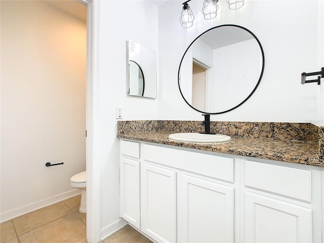 bathroom featuring vanity, toilet, and tile patterned floors