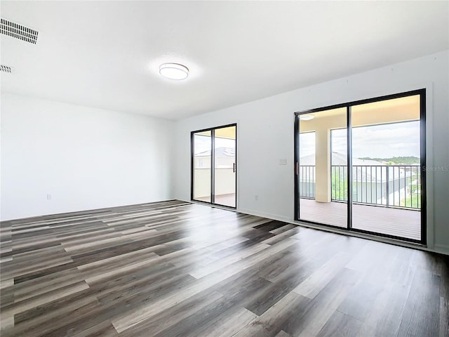 unfurnished room with hardwood / wood-style flooring