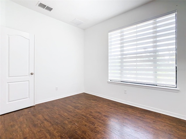 spare room with dark hardwood / wood-style floors