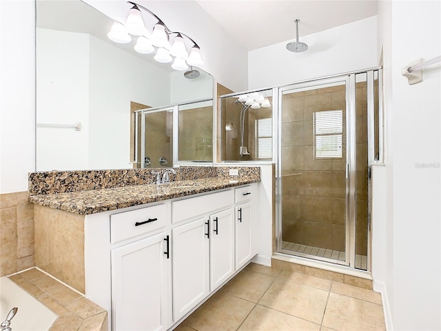 bathroom featuring vanity, walk in shower, and tile patterned flooring