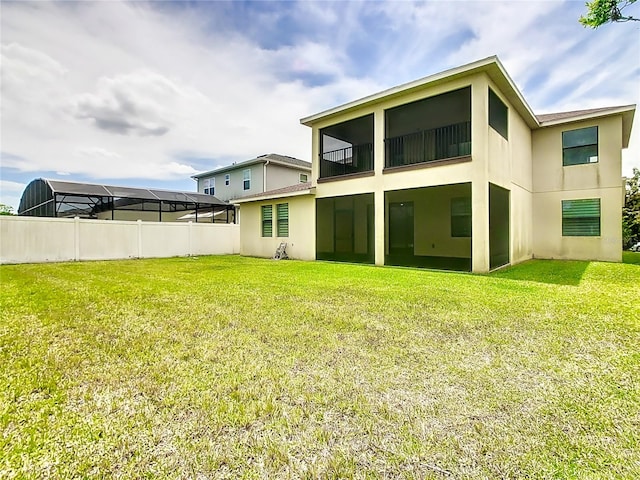 rear view of house with a yard