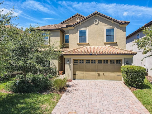 1471 Rolling Fairway Dr, Davenport, FL 33896 - mediterranean / spanish-style house with stucco siding, decorative driveway, and a tile roof