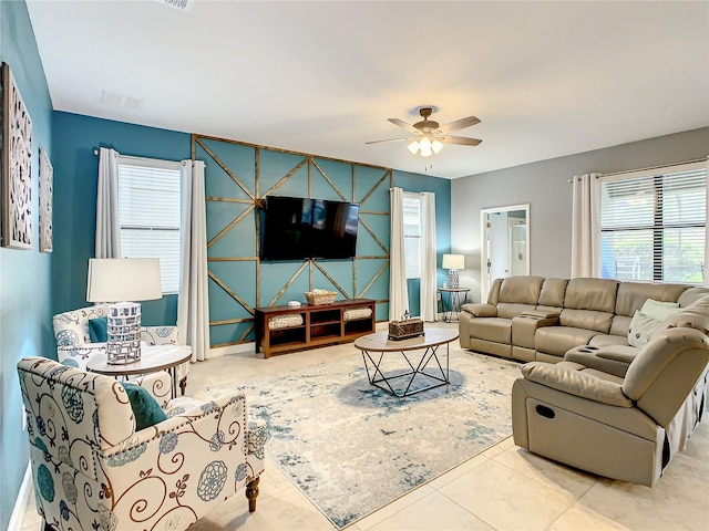 tiled living room with ceiling fan