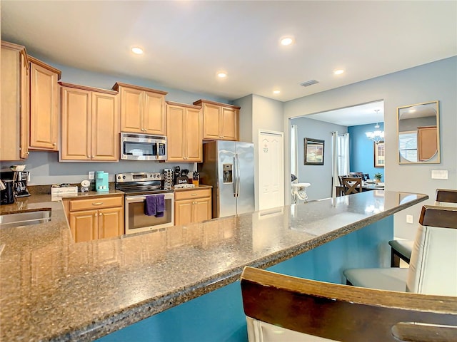 kitchen with a chandelier, sink, stainless steel appliances, and light brown cabinets