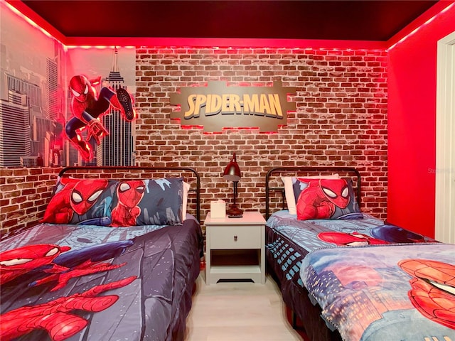 bedroom with brick wall and light colored carpet