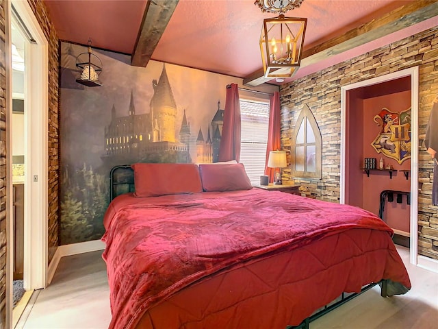 bedroom with beamed ceiling and an inviting chandelier