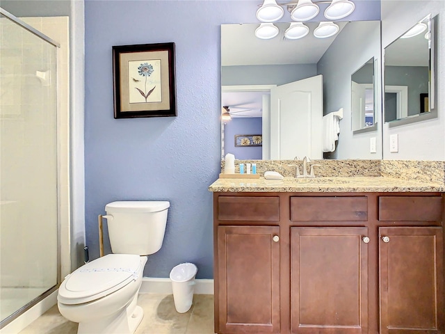 bathroom with vanity, toilet, an enclosed shower, and tile patterned floors