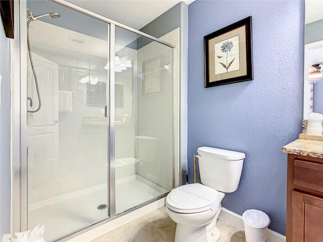 bathroom with an enclosed shower, toilet, and vanity