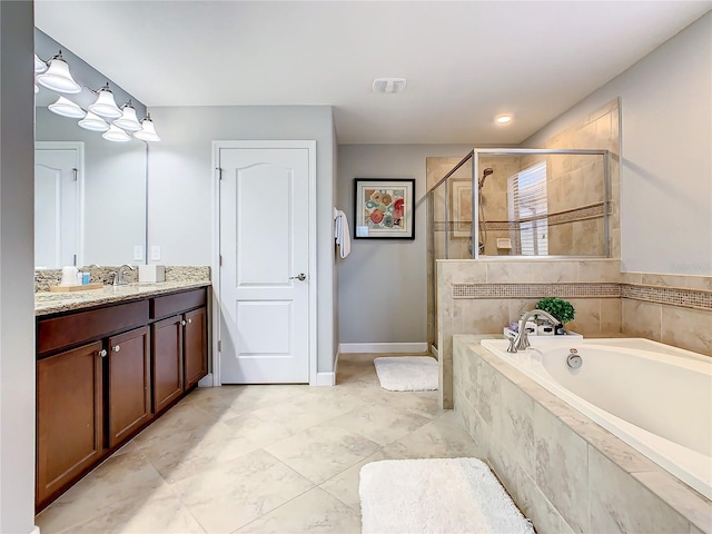 bathroom with vanity and shower with separate bathtub