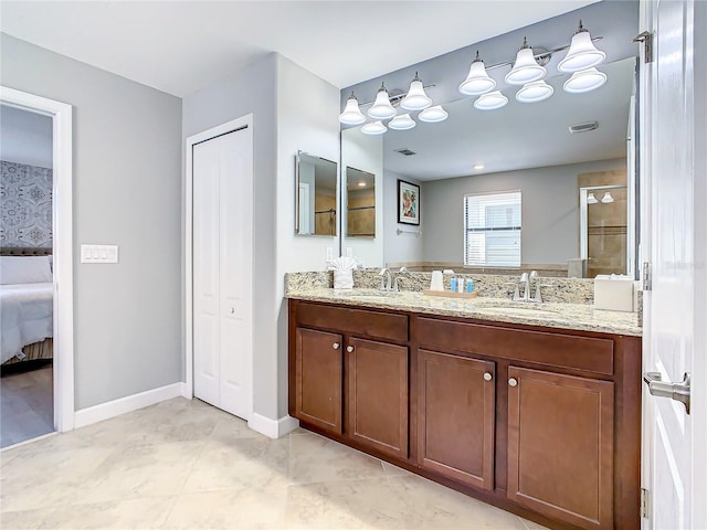 bathroom with tile patterned floors, a tile shower, and vanity